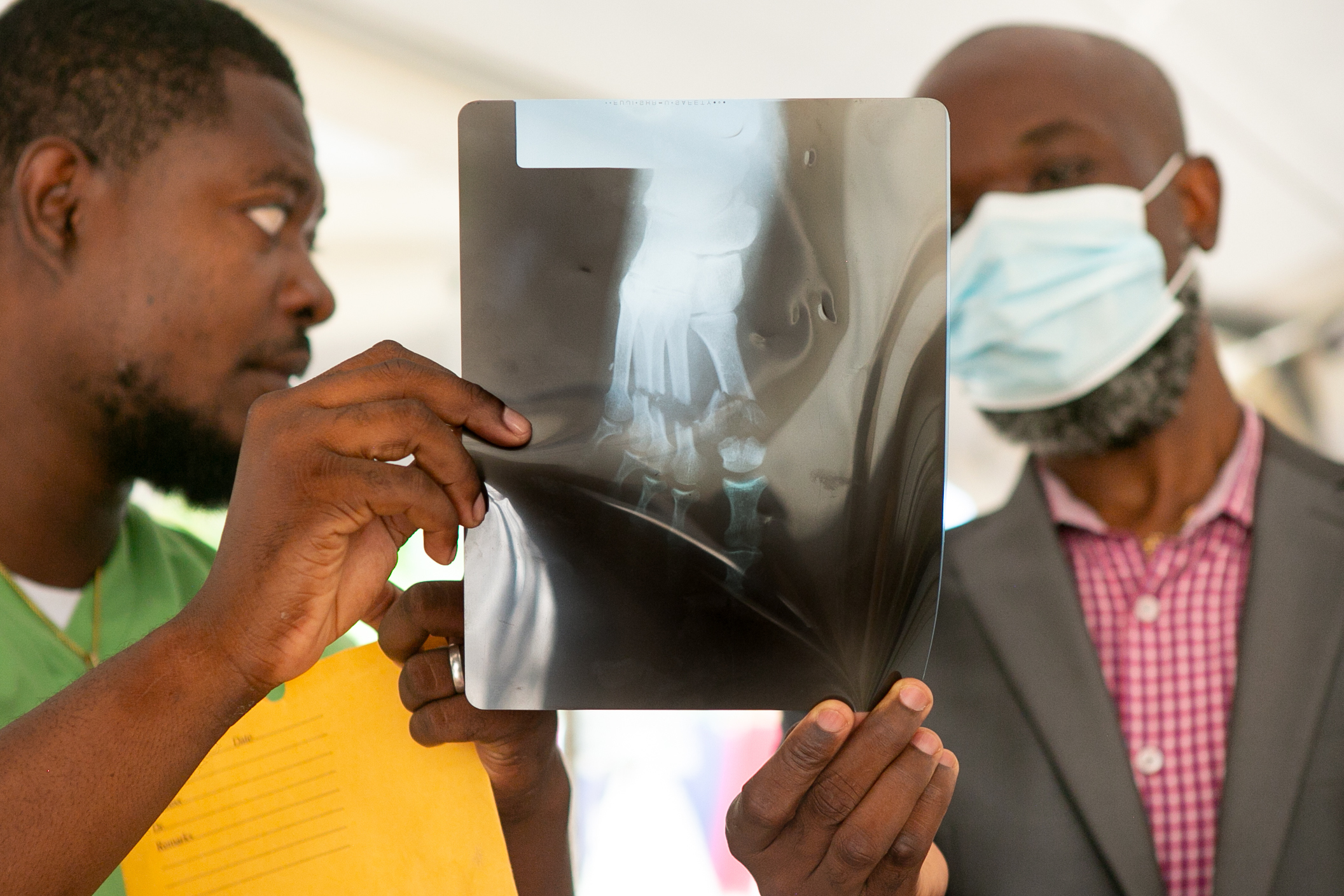 2 Haitian doctors hold up an x-ray of a foot 