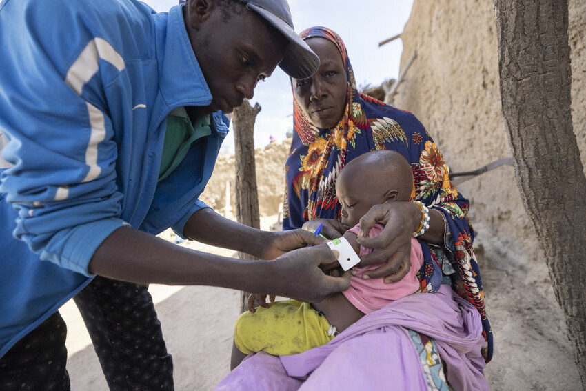 Child being screened for malnutrition.