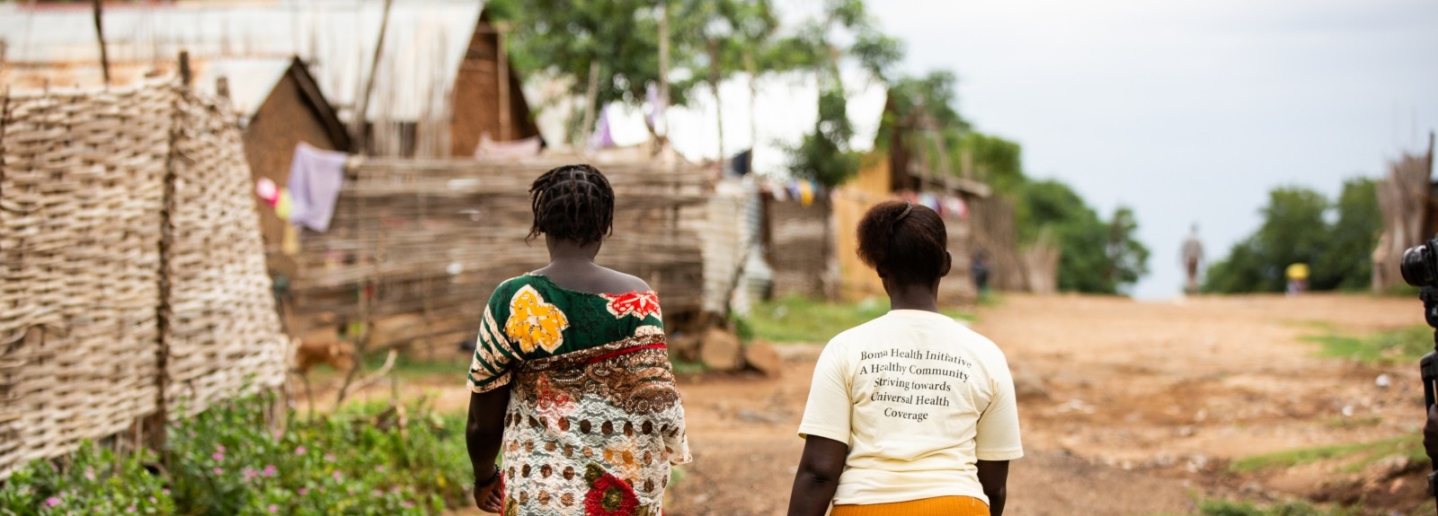 Two women in South Sudan walk to a health clinic