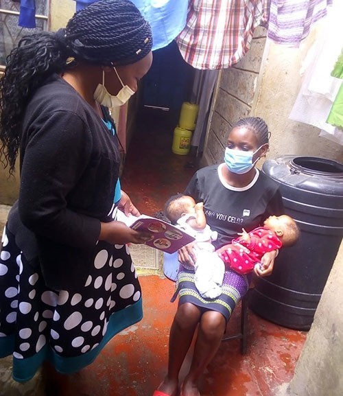 Three months later, Community Health Worker Florence Nthenya visit Lavender Atieno at her house in Kayole to check on her infant's progress following Kangaroo Mother Care.