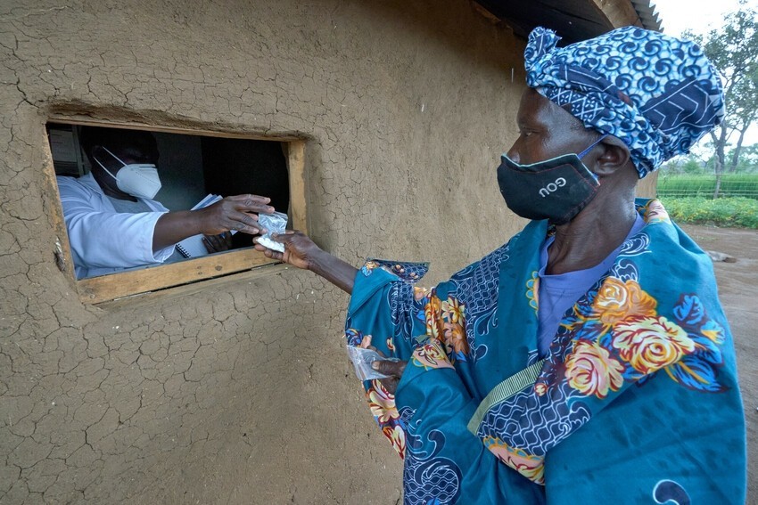 Esther receives prescription medications from the pharmacist at the Meruwa Primary Health Care Center, located in Kajo Keji, South Sudan.
