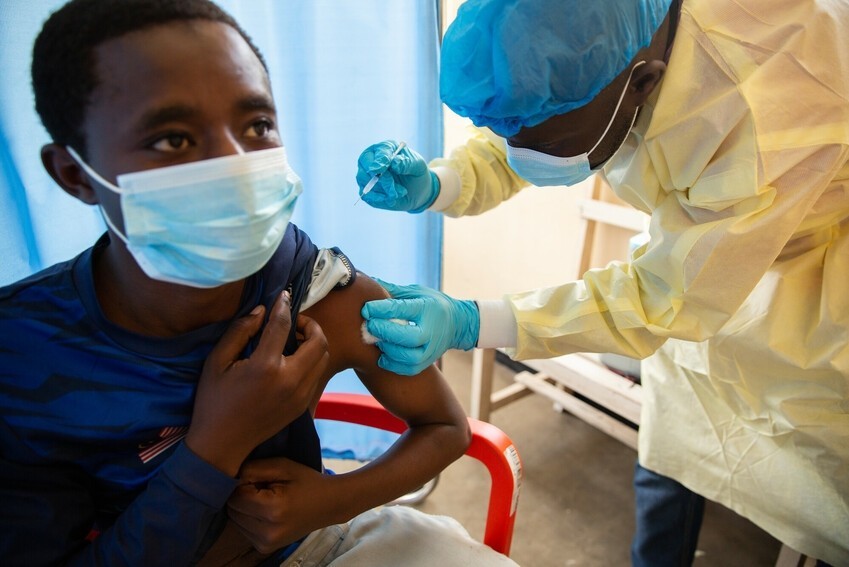 Ernest Chirubala receives his first round of the COVID-19 vaccine from Nurse Kalinda