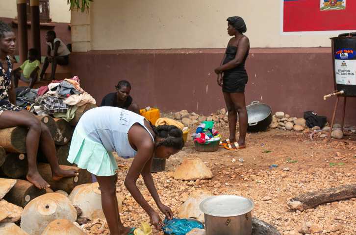 Haitian community members perform daily tasks. 