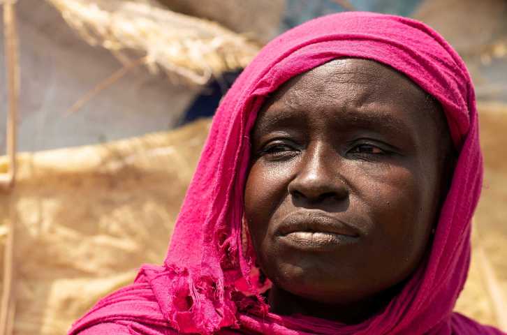 A woman in a pink head scarf