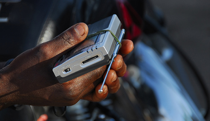 hands of an African with its radio