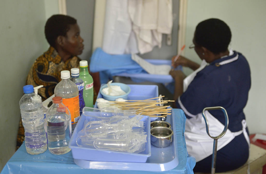 Nurse Moureen Mbise fills out reports after screening Remi Paulo Hengeleka for cervical cancer in the Shirati Hospital in Shirati, Tanzania. (Paul Jeffrey/IMA World Health)