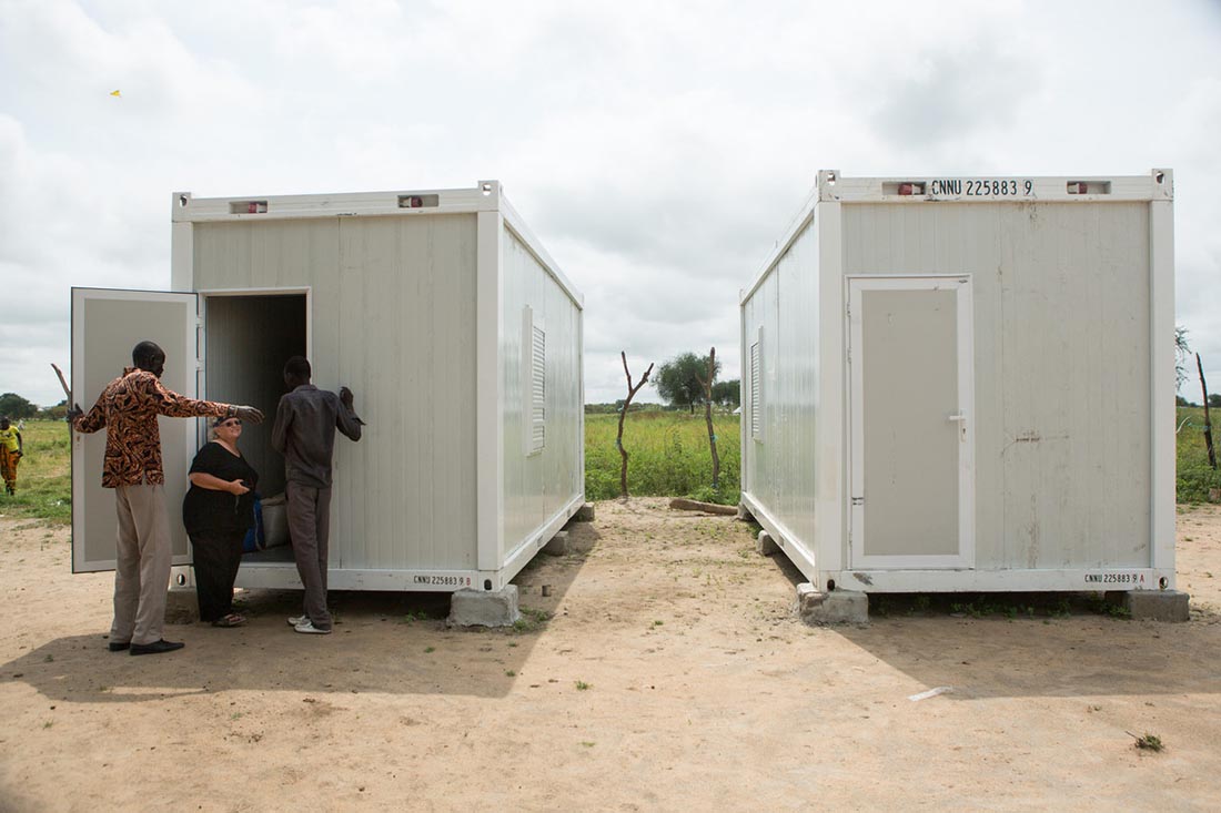 Local staff show Nancy McGaughey, a reproductive health and nutrition advisor with IMA World Health, their just-delivered medical stabilization center units at an IMA World Health clinic site in Duk Payuel in South Sudan's Jonglei state, September 30, 2017. Lutheran World Relief has partnered with IMA World Health to set up and run three life-saving medical stabilization centers identical to this one to treat young children and lactating mothers at risk of death from starvation in the region. The project, called “Providing Emergency Nutrition Services in South Sudan” will reach just under 100,000 individuals. (photo by Allison Shelley for Lutheran World Relief)