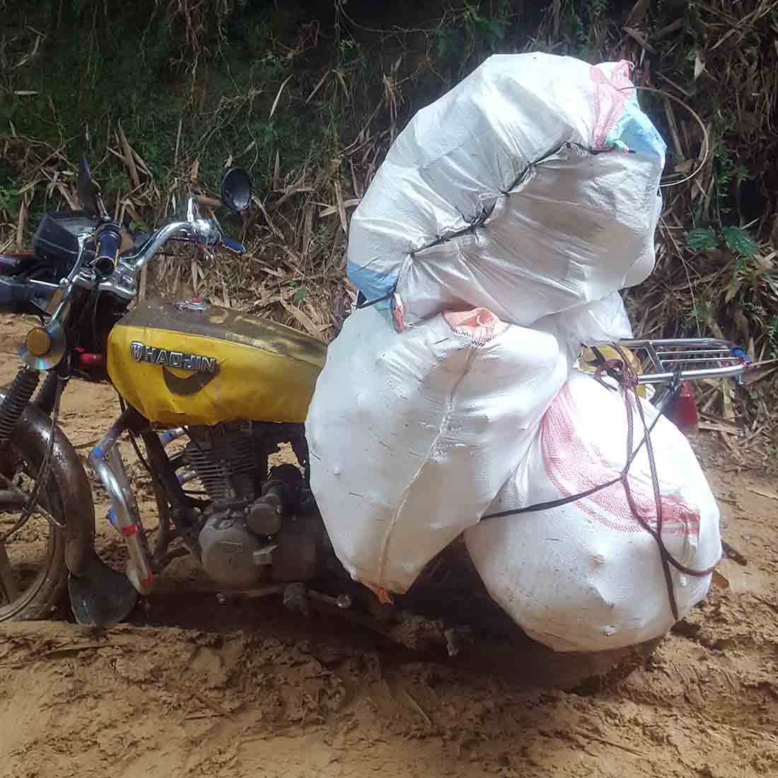Transportation of medical supplies on the Ferekeni route often gets muddy. (Photo by Paulin Kaza/IMA World Health)