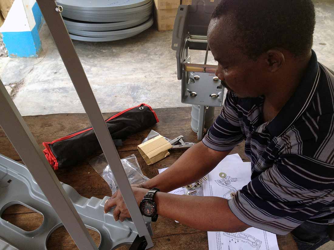 Siméon Avuta prepares the VSAT installation materials in Kananga, Kasai Central. (Photo by Carlos Nyembwe/IMA World Health)