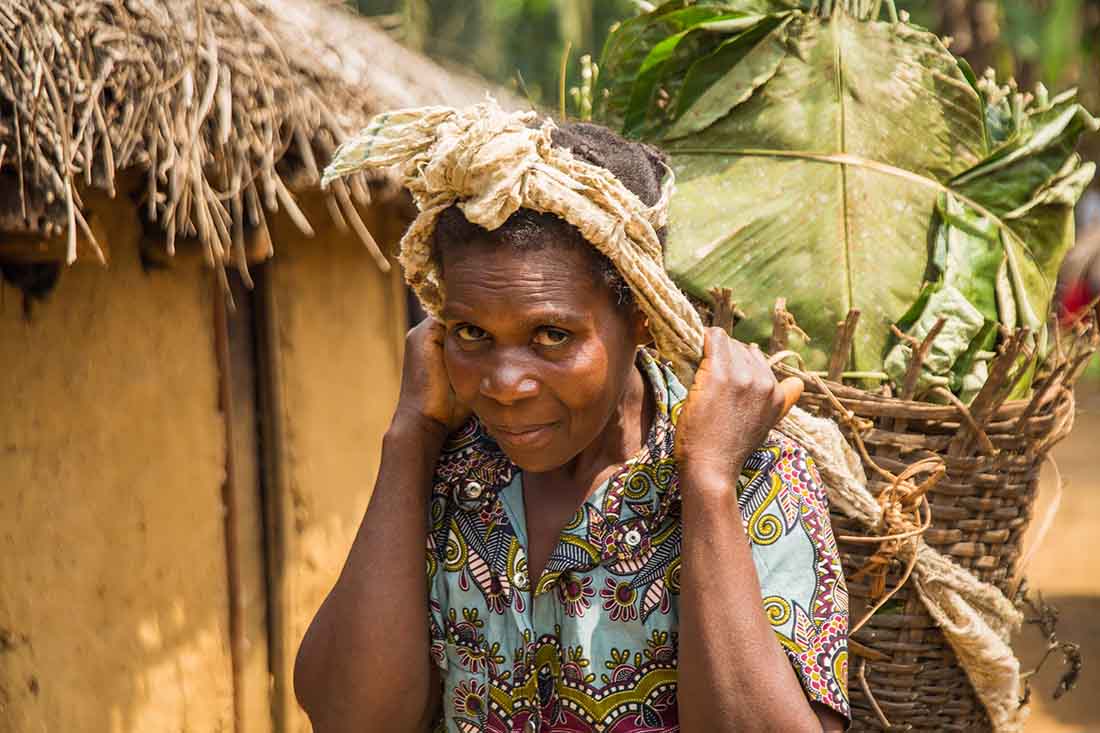 A survivor spends her days foraging in the forest for bananas, which she sells at the market. (Photo by Crystal Stafford/IMA World Health)