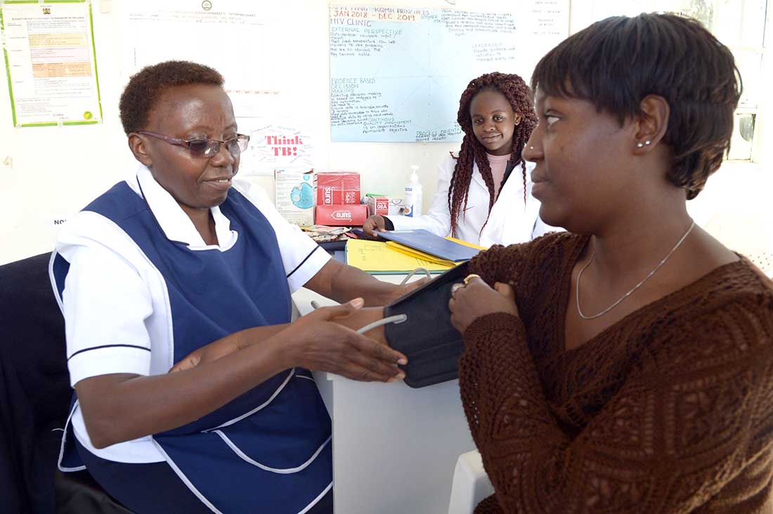 Nurse Elizabeth Michire counsels Mary* at a clinic in Mama Lucy Kibaki Hospital in Nairobi. Looking on is Whitney Adhiambo, a 22-year-old student. (Photo by Matt Hackworth/IMA World Health)