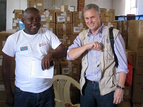 Dr. William Clemmer, right, of IMA World Health and Lutheran World Relief, demonstrates the elbow bump greeting with a colleague.